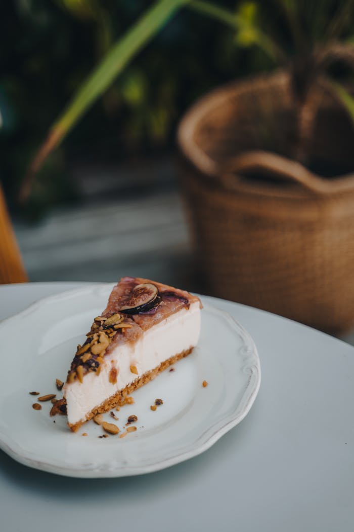 Slice of cheesecake with toppings on a plate, perfect sweet treat.